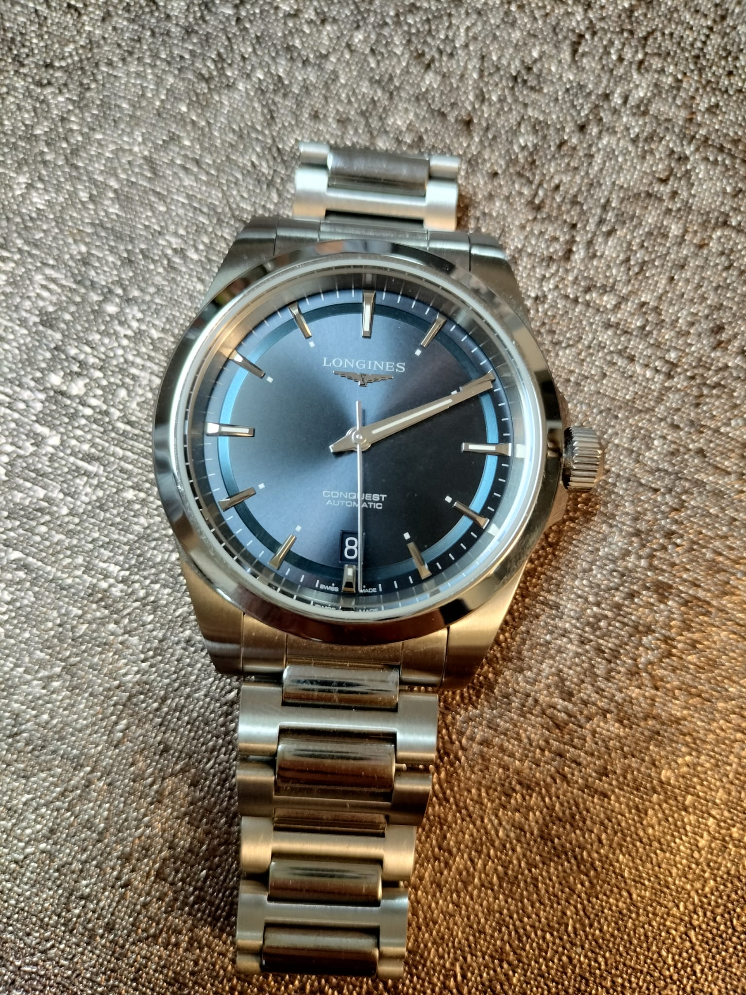 Blue-dial Longines Conquest automatic on a steel bracelet, photographed in 2024